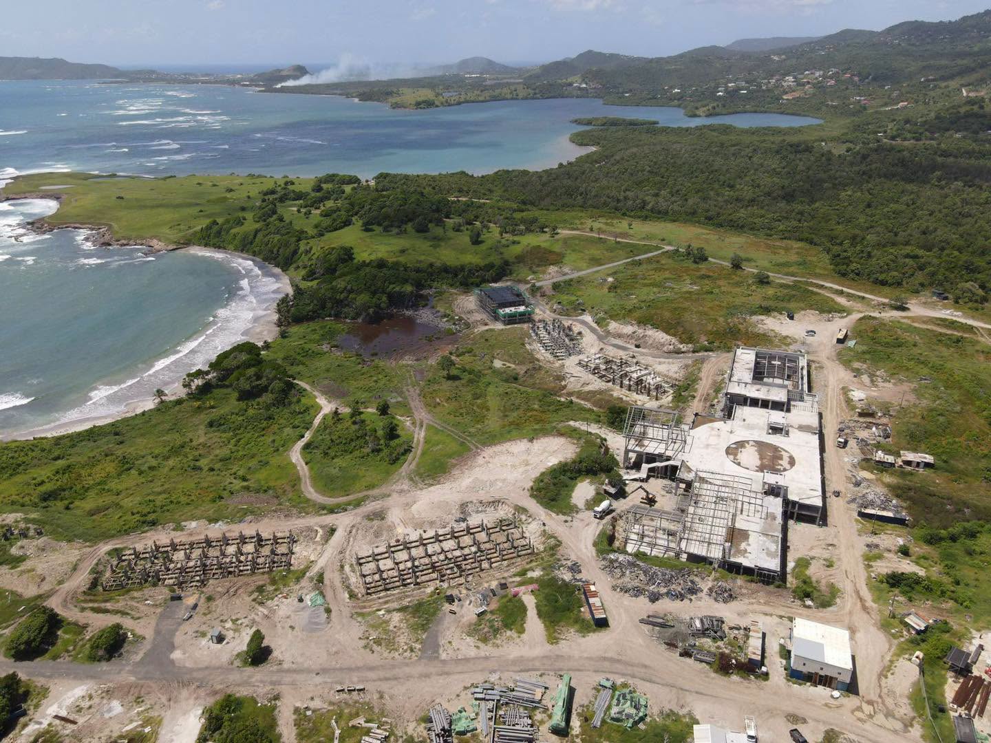 Submitted aerial photograph showing incomplete concrete buildings, stored components and graded roads at the coastal Canelles site